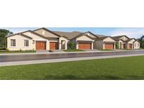 Charming townhome exterior featuring multiple units, attached garages, and manicured lawns at 8466 Course Br, New Port Richey, FL 34655