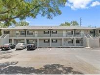 Two-story condominium building featuring individual balconies and ample parking at 101 Lake Ne Ave # 121, Largo, FL 33771