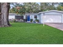 Charming single-story home with a well-manicured lawn and lush landscaping at 1384 S Hillcrest Ave, Clearwater, FL 33756