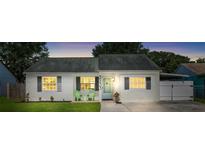 Charming single-story home with a well-maintained lawn, neutral paint, and decorative shutters at 3133 Payne St, New Port Richey, FL 34655