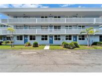 Inviting building with well-maintained lawn and blue doors, offering a welcoming curb appeal at 4895 Bay Ne St # 207, St Petersburg, FL 33703