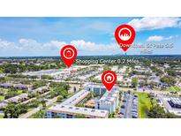 Aerial view of the condo with nearby shopping center and downtown St Pete in the distance at 801 83Rd N Ave # 412, St Petersburg, FL 33702