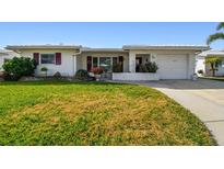 Charming single-story home featuring a well-manicured lawn and inviting curb appeal at 9548 141St St, Seminole, FL 33776