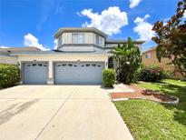 Charming two-story home featuring a two-car garage and tropical landscaping at 11122 Kempton Vista Dr, Riverview, FL 33579
