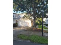 Charming townhome with a stone facade, well-maintained landscaping, and a two-car garage at 19239 Stone Hedge Dr, Tampa, FL 33647