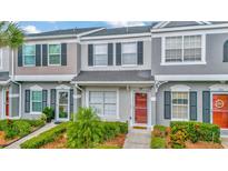 Charming townhome featuring a well-maintained exterior, landscaped yard, and inviting front entrance at 267 Countryside Key Blvd, Oldsmar, FL 34677