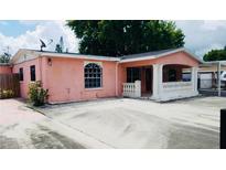Charming one-story home with a concrete porch, columns, and a well-manicured front yard at 4725 Town N Country Blvd, Tampa, FL 33615
