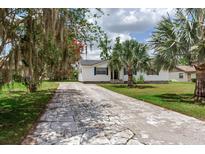 Charming single story home featuring a well-maintained lawn and a long driveway at 5206 Cindy Kay Dr, Plant City, FL 33566