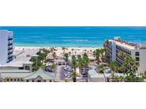 Scenic view of the beach and ocean from beachfront condo with palm trees and resort-style amenities at 5353 Gulf Blvd # A402, St Pete Beach, FL 33706