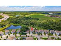Beautiful aerial view of the home with spacious yard, pond, and lots of greenery in the backyard at 8050 Praise Dr, Tampa, FL 33625