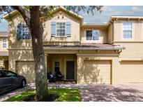 Charming two-story home with blue shutters and a well-maintained brick driveway and lawn at 9317 Stone River Pl, Riverview, FL 33578