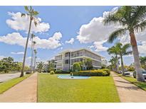Stunning condo building with a well-manicured lawn, beautiful palms, and a charming fountain at 1060 N Shore Ne Dr # 6, St Petersburg, FL 33701