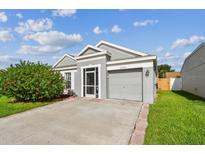 Charming single-story home featuring a well-manicured lawn and attached one car garage at 12413 Dawn Vista Dr, Riverview, FL 33578