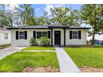 Charming single-story home featuring a well-maintained lawn and freshly painted exterior at 1275 Palm St, Clearwater, FL 33755