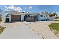 Charming single-story home with a private front yard and attached garage at 2 79Th S St, St Petersburg, FL 33707