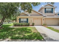Charming townhome with a well-manicured lawn and inviting curb appeal at 20302 Noble Oak Pl, Tampa, FL 33647