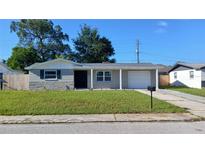 Charming single-story home with a well-maintained front yard and a classic exterior at 3150 Beacon Square Dr, Holiday, FL 34691