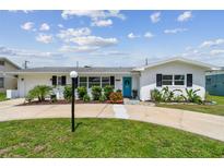 Charming single-story home featuring a bright blue front door and well-maintained landscaping at 3545 59Th N Ln, St Petersburg, FL 33710