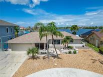 Waterfront home features a two-car garage, landscaping, and charming curb appeal in a waterfront community at 6334 Cocoa Ln, Apollo Beach, FL 33572