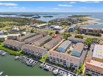 Stunning aerial view of waterfront condo community with boat slips and easy access to bay and gulf waters at 1109 Pinellas Bayway S # 306, Tierra Verde, FL 33715