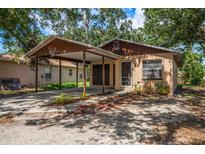 Charming single-story home featuring a carport, tidy landscaping, and classic curb appeal at 15623 Morgan St, Clearwater, FL 33760