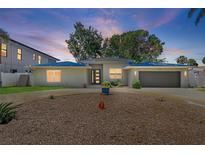 Charming home with a gray exterior, circular driveway, and manicured landscaping at 2650 W Bay Isle Se Dr, St Petersburg, FL 33705