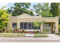 Charming single-story home featuring a stucco exterior, inviting porch, and attached carport for convenient parking at 3611 W Bay To Bay Blvd, Tampa, FL 33611
