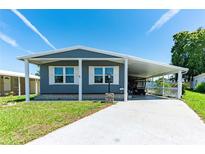 Charming single-story home with a covered carport and well-maintained front yard and visible street address at 36435 Bonney Dr, Zephyrhills, FL 33541