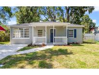 Charming single-story home with a cozy front porch, fresh landscaping, and a well-maintained lawn at 3907 W Walnut St, Tampa, FL 33607