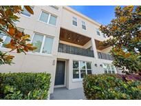 Beautiful townhouse showcasing a private balcony, stucco facade, and well-kept landscaping at 4913 N Nebraska Ave # 5, Tampa, FL 33603