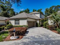 Charming home featuring a well-manicured lawn, a two-car garage, and neutral colored stucco siding at 5224 Fairway One Dr, Valrico, FL 33596