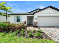 Charming single-Gathering home with a manicured front yard and brick paver driveway and walkway at 5336 Patano Loop, Palmetto, FL 34221