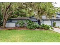 Charming single-story home with a well-manicured lawn and mature trees in a serene setting at 60 Birdsong Ct, Oldsmar, FL 34677