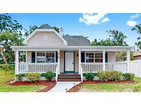 Charming single-story home featuring a welcoming front porch, well-maintained landscaping, and a freshly painted exterior at 1005 45Th W St, Bradenton, FL 34209
