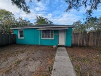 Charming one-story home with a teal exterior and a welcoming front entrance with walkway at 1028 E 93Rd Ave # A, Tampa, FL 33612