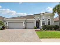 Beautiful single-story home featuring a three-car garage and a well-manicured front yard at 12004 Cinnamon Fern Dr, Riverview, FL 33579