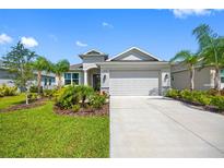 Beautiful home with a well-manicured lawn, lovely landscaping, and a spacious two-car garage at 12739 Rainwashed Loop, Parrish, FL 34219