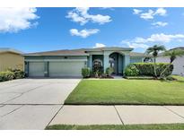 Charming single-story home with three-car garage and well-manicured lawn at 12904 Prestwick Dr, Riverview, FL 33579