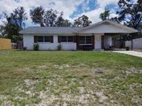 Charming single-story home with a carport and well-maintained front lawn at 1922 Marvy Ave, Tampa, FL 33612