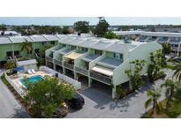 Charming townhomes with a shared pool, private carports, and balconies for outdoor living at 318 Windrush Blvd # 10, Indian Rocks Beach, FL 33785