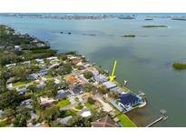 Waterfront home featuring a private dock, lush landscaping, and stunning views of the bay in a desirable neighborhood at 3290 Sunset N Dr, St Petersburg, FL 33710