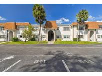 Exterior of building with parking spots, grass and palm trees at 345 S Mcmullen Booth Rd # 142, Clearwater, FL 33759