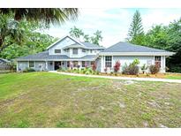 Beautiful two-story home with mature landscaping and a welcoming walkway leading to the front door at 35 Deerpath Dr, Oldsmar, FL 34677