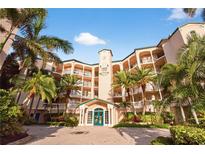 Stunning condo building featuring lush landscaping, arched balconies, and a welcoming entrance at 5430 Eagles Point Cir # 202, Sarasota, FL 34231