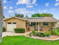 Charming single-story home with stone accents, a front pond, and a well-manicured lawn at 5726 20Th N Ave, St Petersburg, FL 33710