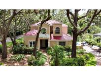 Inviting home boasts a red tile roof and mature landscaping, creating a private, serene setting at 16006 Armistead Ln, Odessa, FL 33556