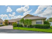 Charming single-story home with well-maintained landscaping, bright flowers, and a private driveway at 1717 Atrium Dr, Sun City Center, FL 33573