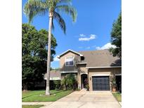 Charming two-story home boasts a well-manicured lawn, attached garage, and mature landscaping at 5139 Corvette Dr, Tampa, FL 33624