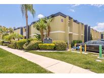 Exterior view of 1301 SOHO Condominiums with lush landscaping and a manicured lawn at 1301 S Howard Ave # A9, Tampa, FL 33606