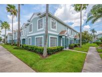 Inviting two-story townhouse featuring neat landscaping, mature palms, and a clean, modern color palette at 1312 Kelridge Pl, Brandon, FL 33511